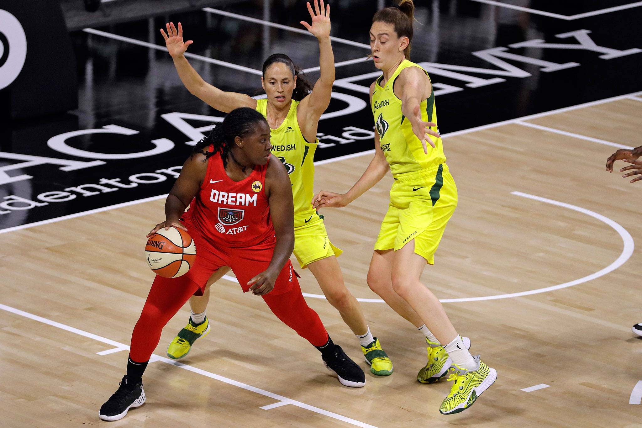 Storm guard Sue Bird (10) and forward Breanna Stewart (30) defend Dream forward Shekinna Stricklen during the first half of a WNBA game Aug. 12, 2020, in Bradenton, Fla. (AP Photo/Chris O’Meara)