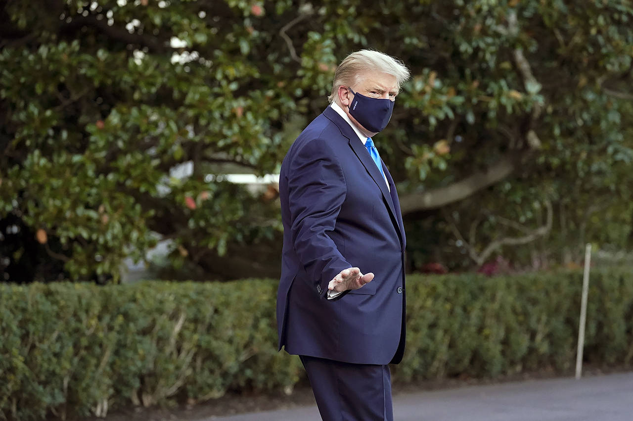 President Donald Trump waves to members of the media as he leaves the White House to go to Walter Reed National Military Medical Center after he tested positive for COVID-19, Friday in Washington. (AP Photo/Alex Brandon)