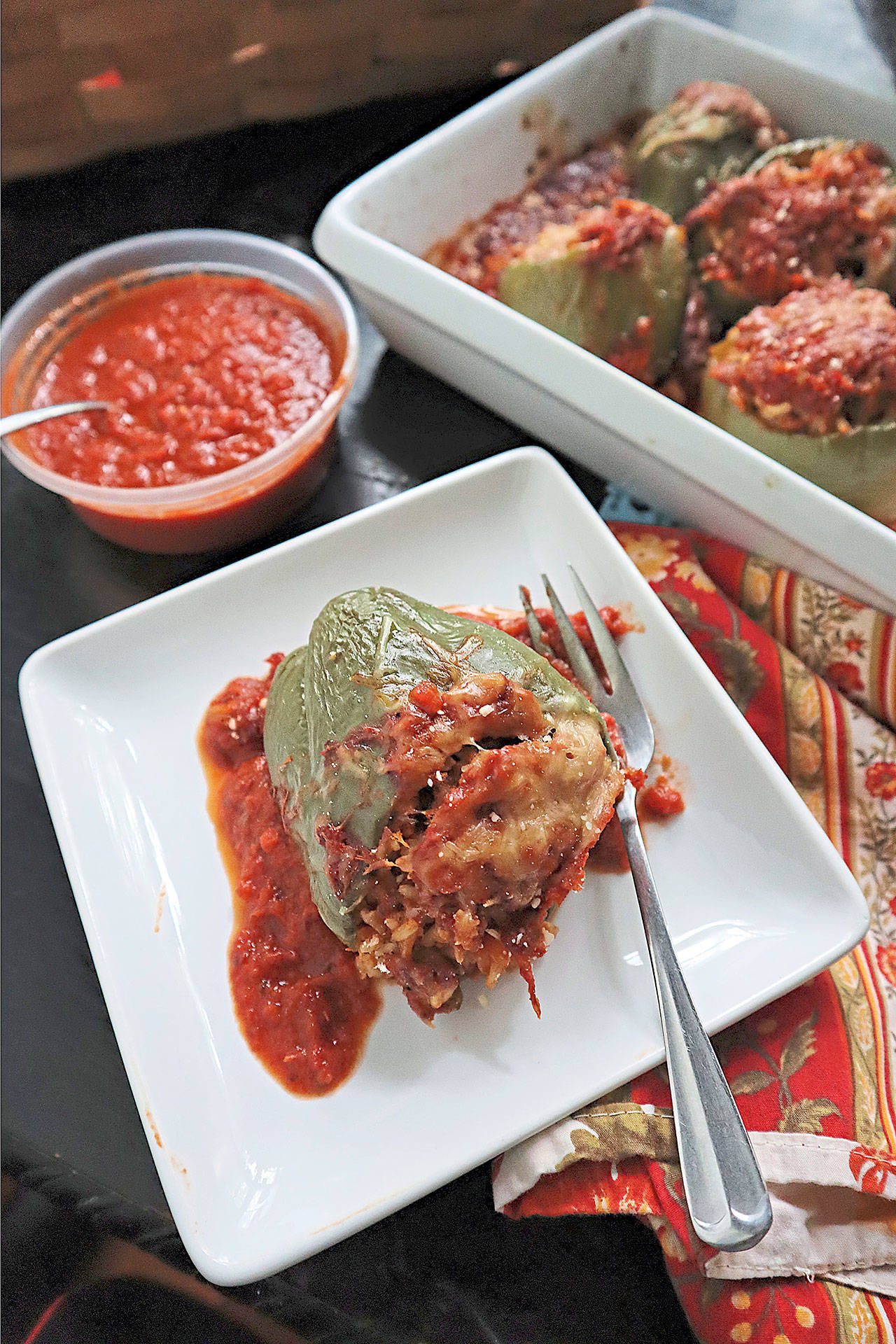 Bell peppers stuffed with a cheesy mixture of sweet Italian sausage, brown rice and Parmesan cheese make a hearty fall meal. (Gretchen McKay / Pittsburgh Post-Gazette)
