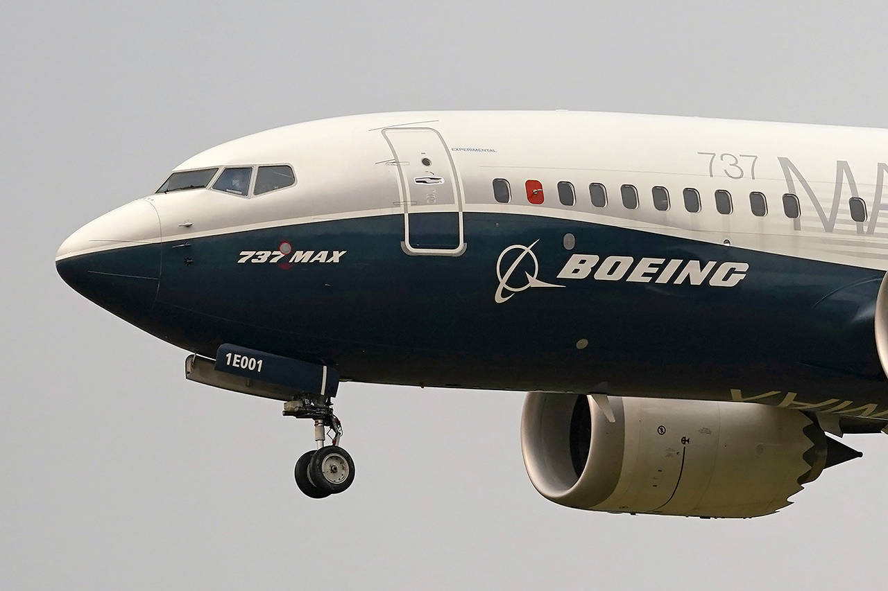 In this Sept. 30 photo, a Boeing 737 Max jet, piloted by Federal Aviation Administration (FAA) chief Steve Dickson, prepares to land at Boeing Field following a test flight in Seattle. (AP Photo/Elaine Thompson, File)