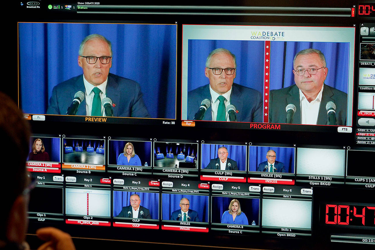 Washington gubernatorial candidates Gov. Jay Inslee, a Democrat, left, and Loren Culp, a Republican, right, are shown on a monitor in a video control room at the studios of TVW, Wednesday, Oct. 7, 2020, in Olympia, Wash., as they take part in a debate. Due to concerns over COVID-19, each candidate took part in the debate from individual rooms separate from moderators. (AP Photo/Ted S. Warren)