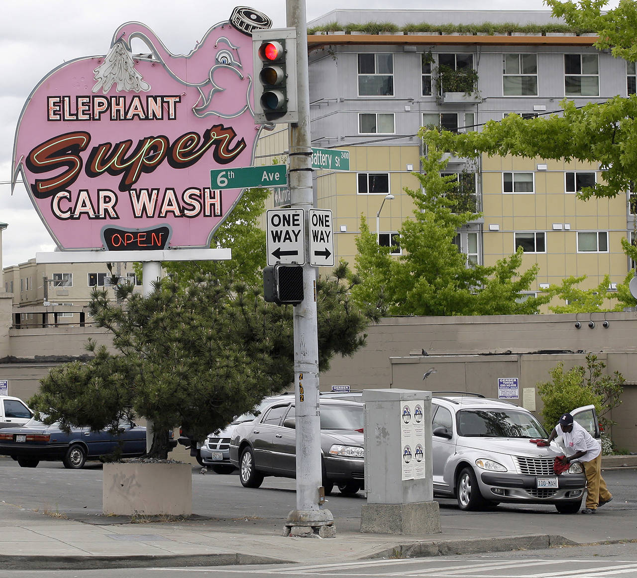 In this 2009 photo, a worker dries a car at Seattle’s famous Elephant car wash, near the Space Needle in Seattle. (AP Photo/Ted S. Warren, File)