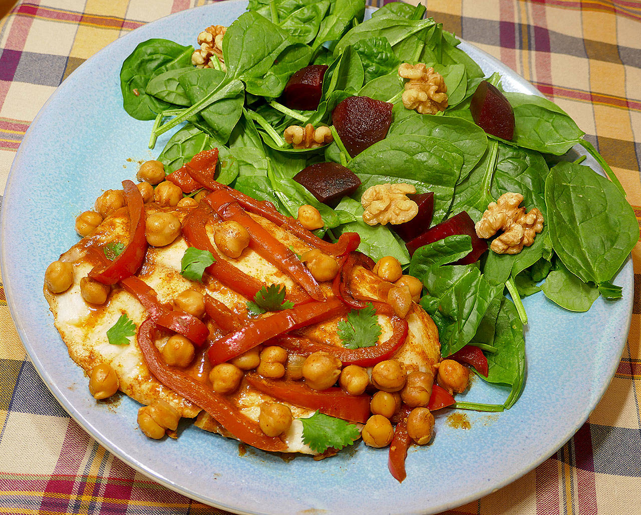 This North African fish stew with spinach and beet salad was adapted from a recipe by cookbook author Yaniv Cohen. (Linda Gassenheimer)