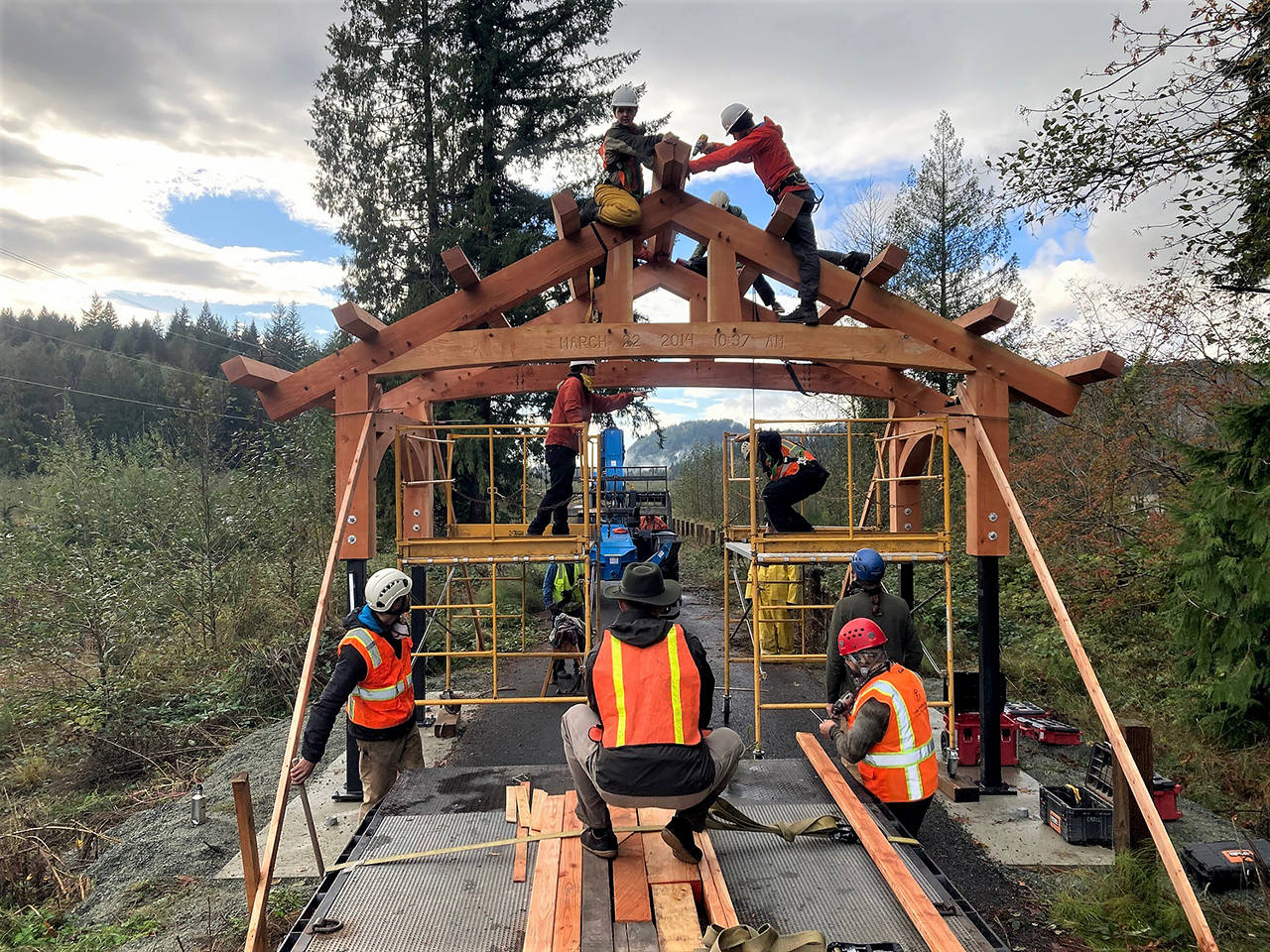 Volunteers with the Timber Framers Guild work Saturday to raise one of two Douglas fir portals at the site of the Oso Slide Memorial. The volunteers crafted the portals at the Monroe fairgrounds. (Snohomish County Parks photo)