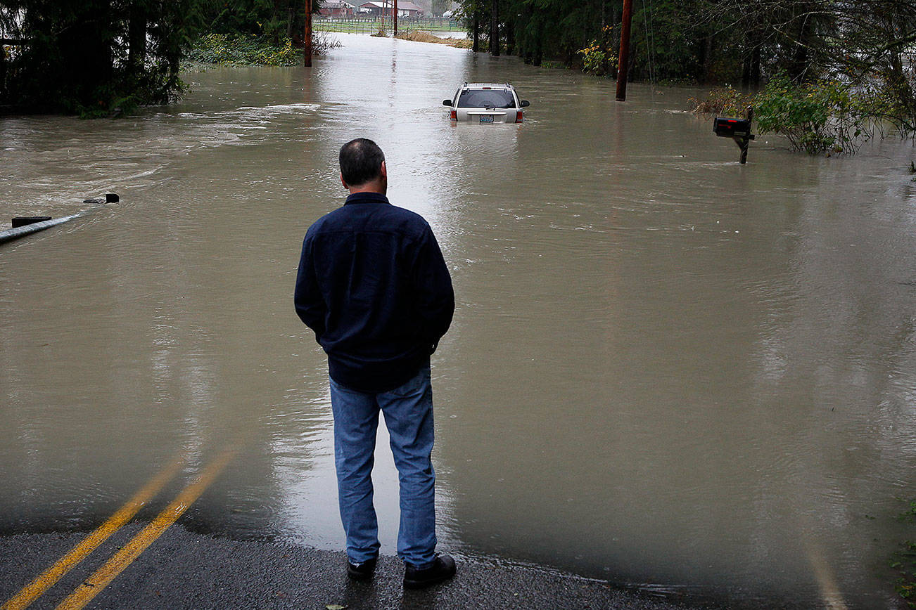 Ian Terry / The HeraldAn abandoned car sits on flooded Mann Road in Sultan on Friday, Nov. 13, 2015.Photo taken on 11132015