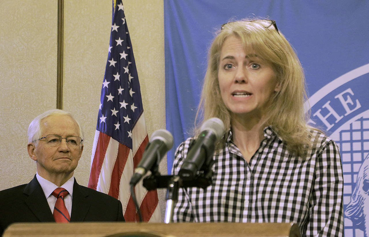 State Health Officer Dr. Kathy Lofy speaks to the media about the coronavirus outbreak, as Insurance Commissioner Mike Kriedler looks on, March 5 in Olympia. (AP Photo/Rachel La Corte, file)
