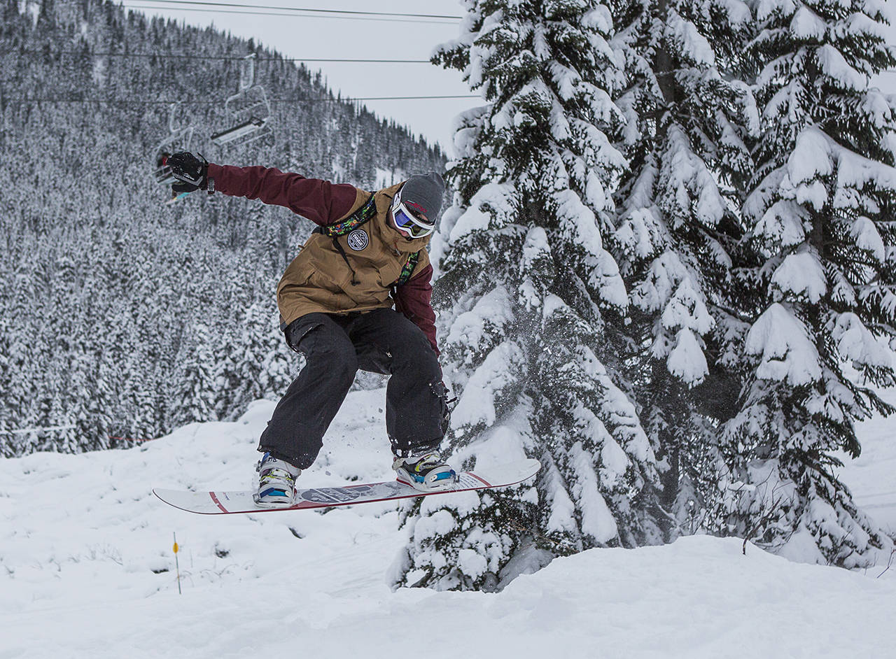 Ryan Leveck makes a jump as he makes his way down the slopes on the opening day of Stevens Pass in 2019. (Olivia Vanni / Herald file)