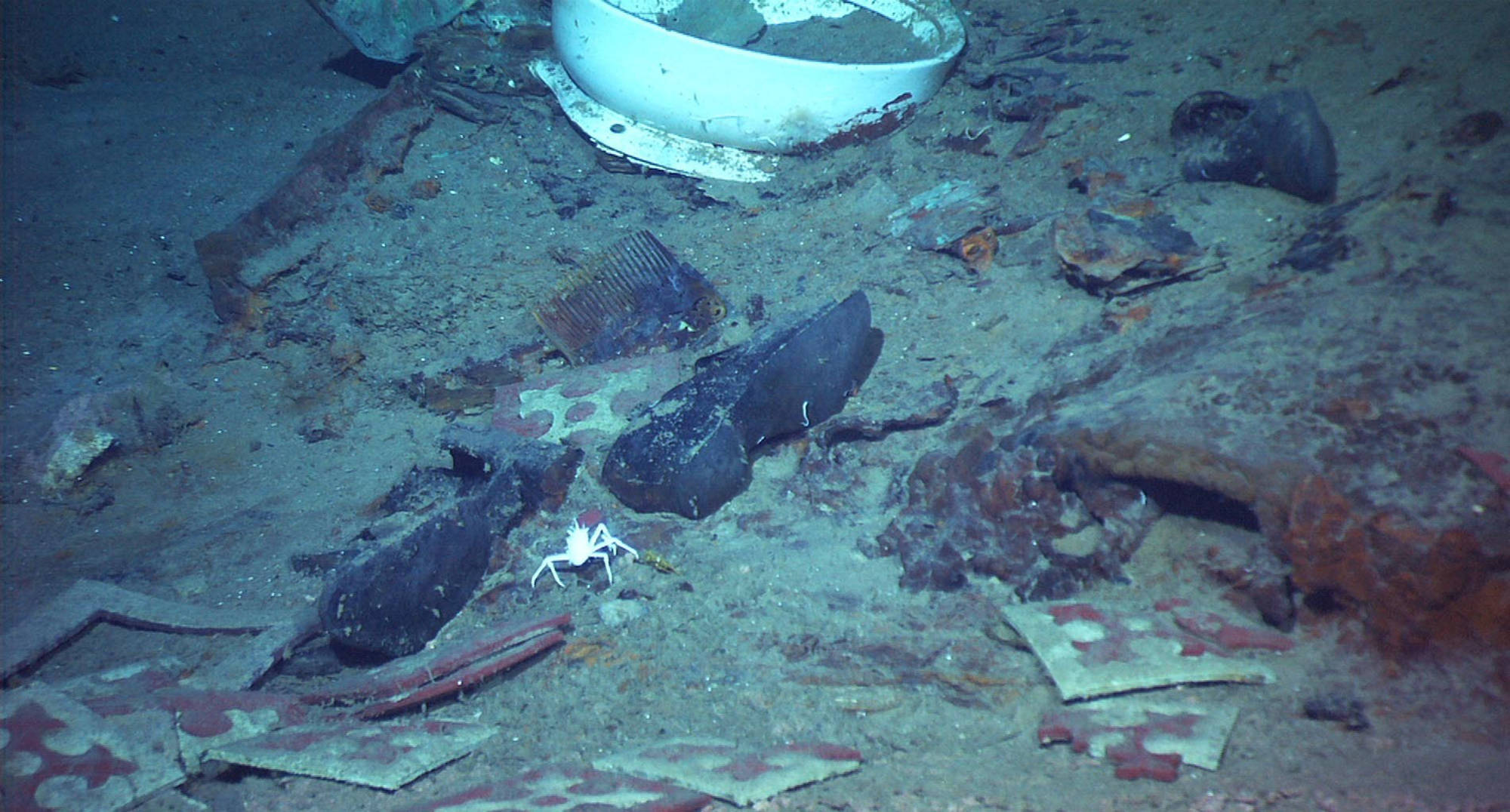 This 2004 image provided by the University of Rhode Island's Institute for Exploration and Center for Archaeological Oceanography and the National Oceanic and Atmospheric Administration's Office of Ocean Exploration shows the shoes of one of the possible victims of the Titanic disaster. A company’s plan to retrieve the Titanic’s radio has sparked a debate over whether the famous shipwreck still holds human remains. (Institute for Exploration and Center for Archaeological Oceanography/University of Rhode Island/NOAA Office of Ocean Exploration via AP)