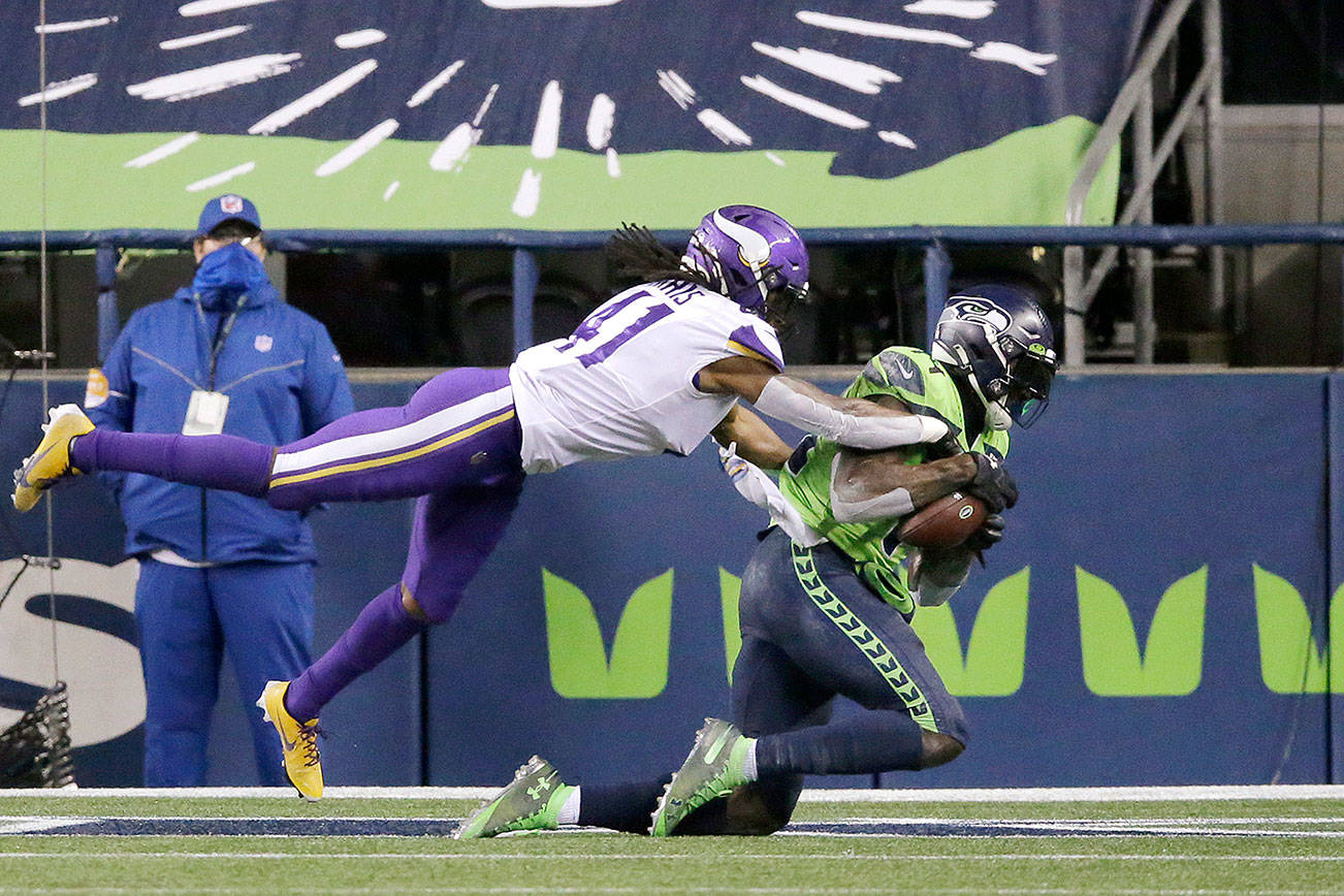 Seattle Seahawks receiver DK Metcalf, right, catches the game-winning touchdown as Minnesota’s Anthony Harris defends in Seattle’s 27-26 victory over the Vikings on Oct. 11 at CenturyLink Field. (AP Photo/John Froschauer)