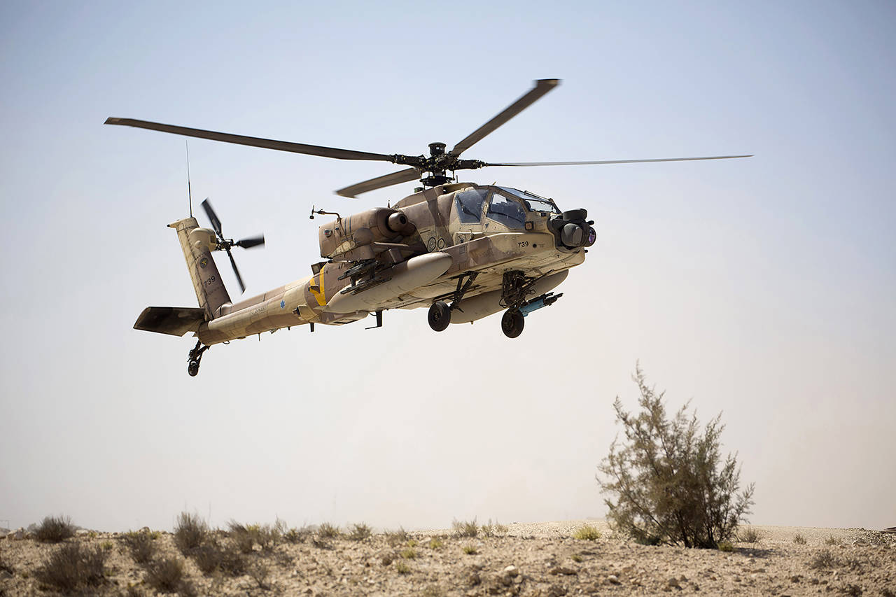An Israeli Air Force Boeing AH-64 Apache attack helicopter from the 113th Squadron, also known as the Hornet Squadron, lands during a display for the foreign press in Ramon air force base near the Israeli town of Mitzpe Ramon on Oct. 21, 2013. (AP Photo/Ariel Schalit, file)