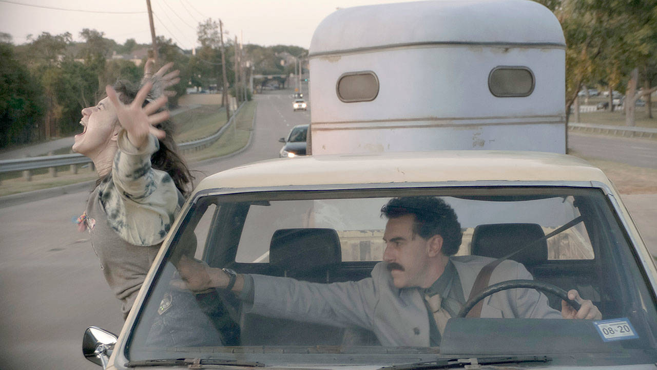 Maria Bakalova and Sacha Baron Cohen in a scene from “Borat Subsequent Moviefilm.” (Amazon Studios)