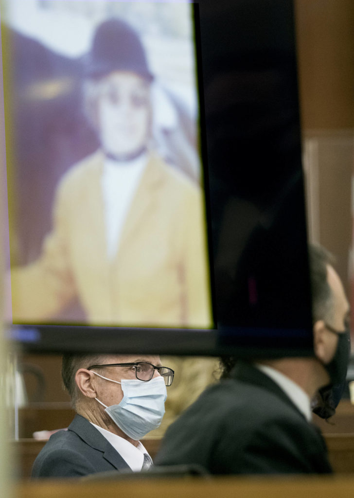 Terrence Miller watches as deputy prosecutor Craig Matheson makes an opening statement at the Snohomish County Courthouse on Monday in Everett. Miller is accused of the 1972 murder of Jody Loomis, seen in a photo wearing horse-riding riding gear. (Andy Bronson / The Herald)
