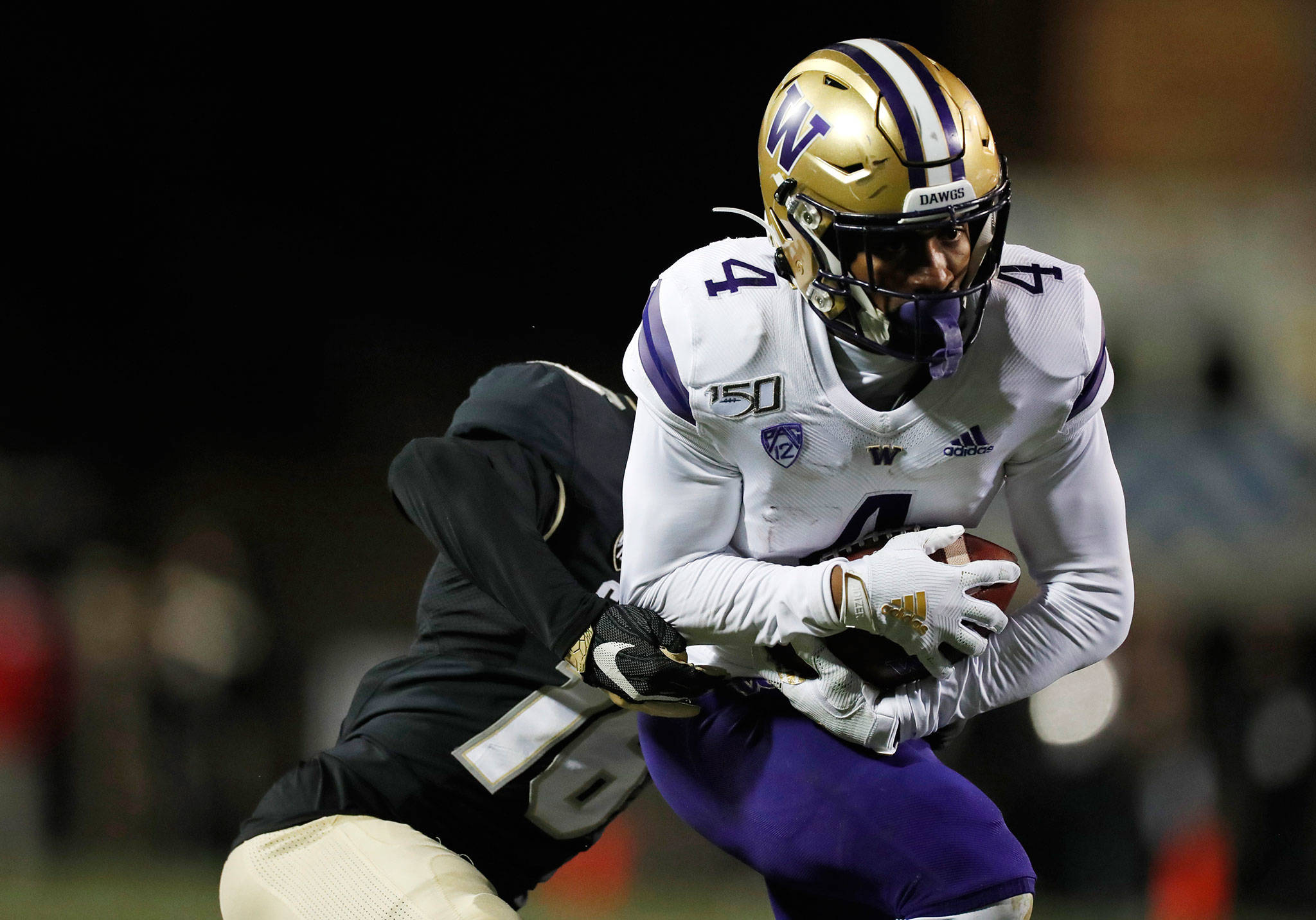 Washington wide receiver Terrell Bynum (right) hauls in a pass as Colorado defensive back Tarik Luckett defends during the second half of a game Nov. 23, 2019, in Boulder, Colo. (AP Photo/David Zalubowski)