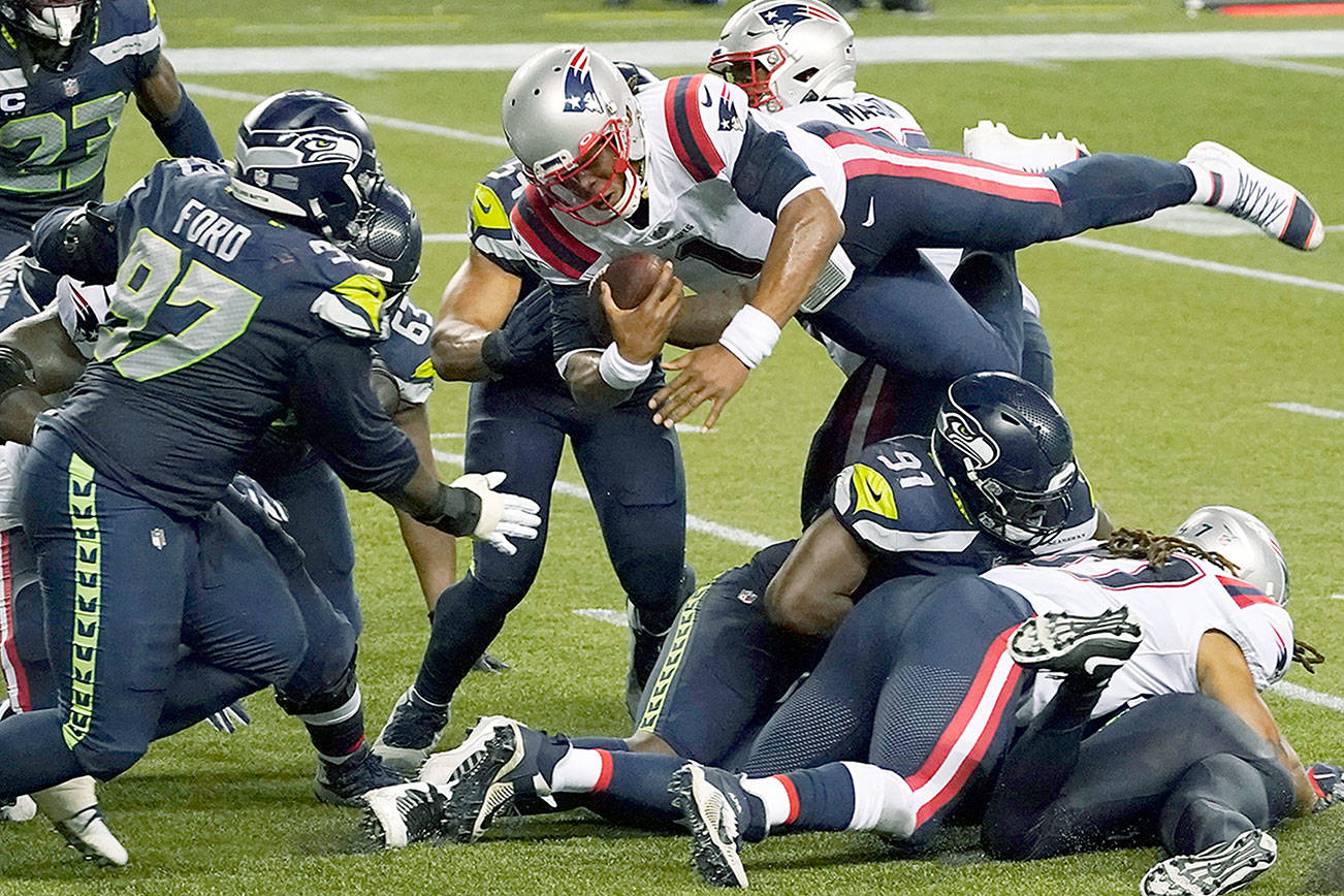 New England Patriots quarterback Cam Newton dives with the ball, but is stopped near the goal line as the clock expires in the fourth quarter of the Seattle Seahawks’ 35-30 victory on Sept. 20 at CenturyLink Field. (AP Photo/Elaine Thompson)