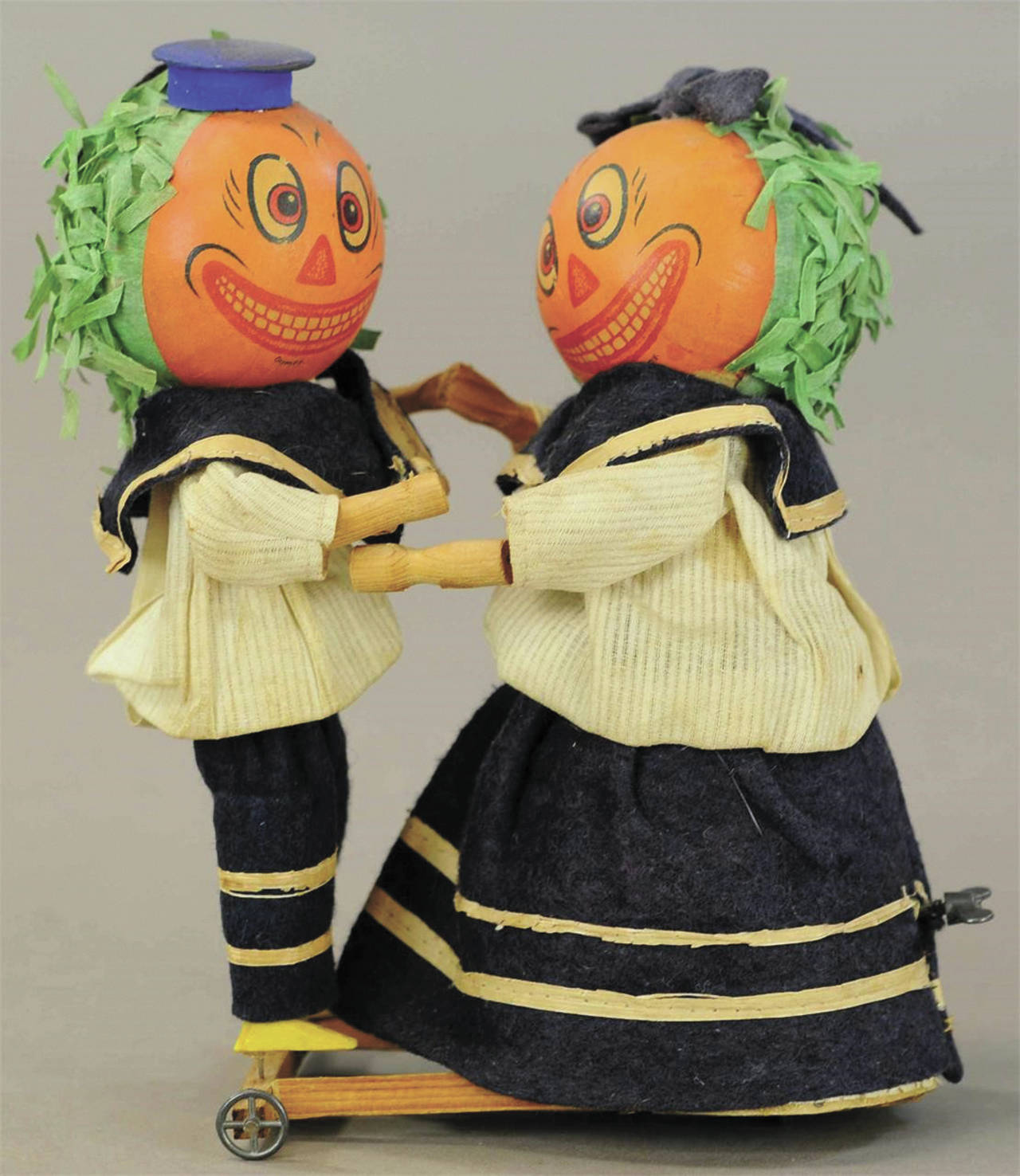 The pumpkin-head dancers are wearing their original blue felt and cotton sailor outfits. They are 8½ inches tall and in excellent working condition, so a collector paid $1,920. (Cowles Syndicate Inc.)