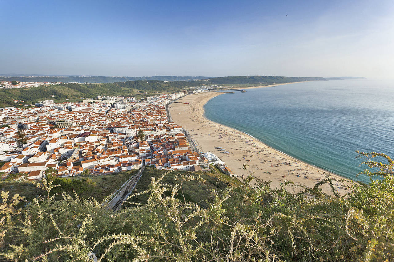 Nazare, a fishing-town-turned-tourist-retreat in Portugal, hugs its wide beach on the Atlantic. (Rick Steves’ Europe)