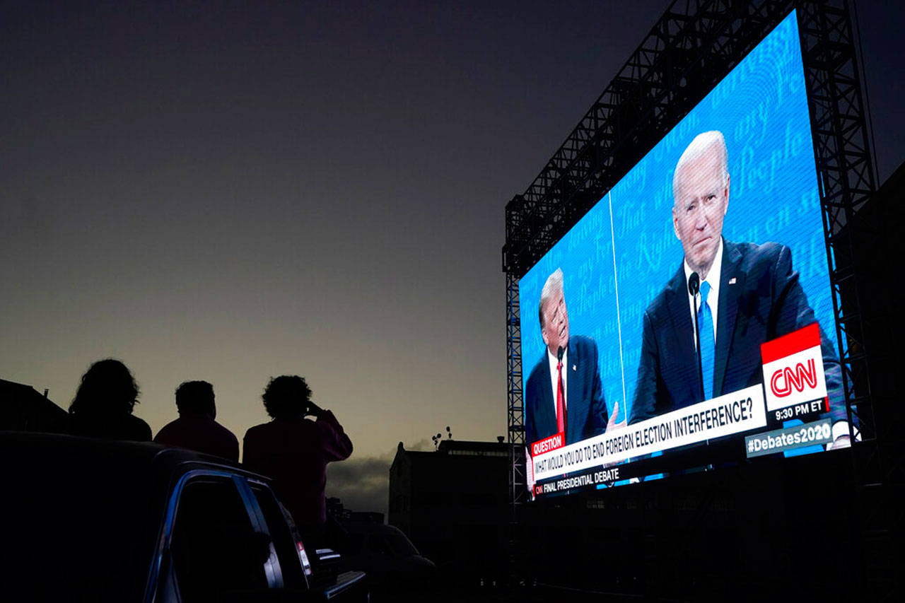 People watch from their vehicle as President Trump and Democratic presidential candidate former Vice President Joe Biden speak during a Presidential Debate Watch Party at Fort Mason Center in San Francisco, Thursday. (Jeff Chiu / Associated Press)