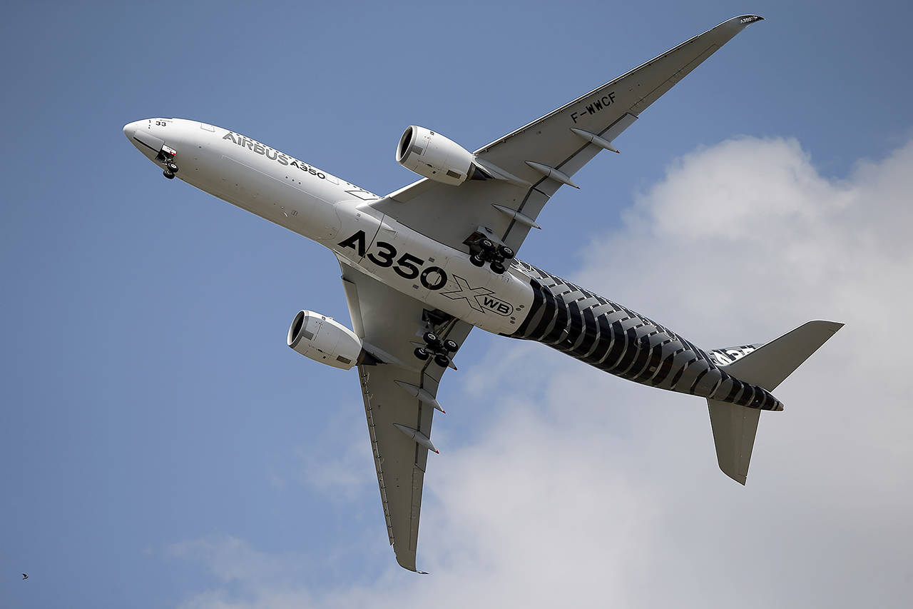 An Airbus A350 performs a demonstration flight at the Paris Air Show in 2015 at Le Bourget airport. (AP Photo/Francois Mori, File)