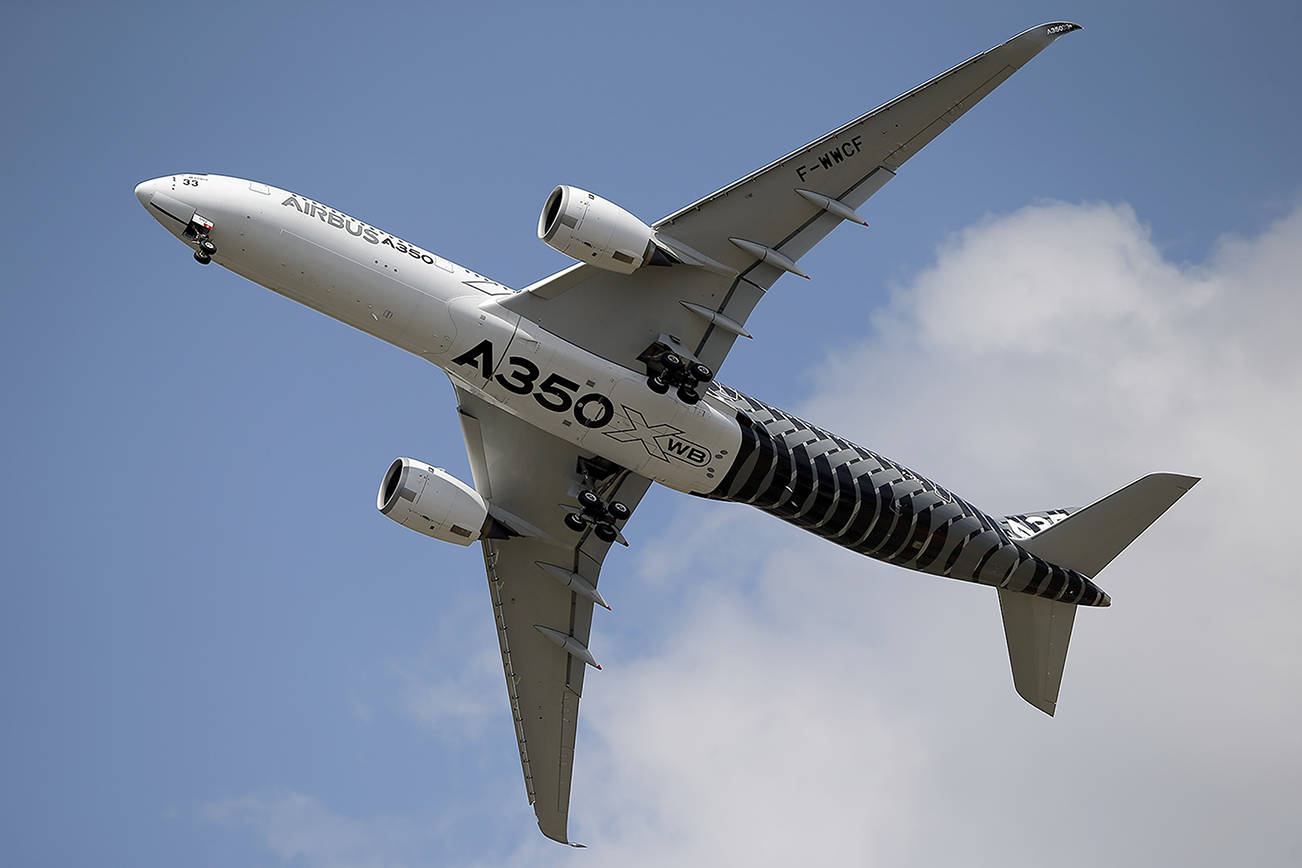 FILE - In this June 17, 2015 file photo, an Airbus A350 performs a demonstration flight at the Paris Air Show, in Le Bourget airport, north of Paris. Airbus announced Wednesday Jan. 11, 2017 that it delivered 688 planes over the year, primarily in the single-aisle A320 family, compared with 635 in 2015. The company increased deliveries of its long-delayed A350 wide-body. (AP Photo/Francois Mori, File)