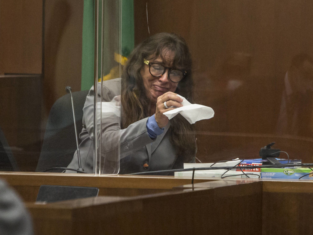 Jana Smith becomes emotional while looking at photographs during her testimony Wednesday in Everett. (Olivia Vanni / The Herald)
