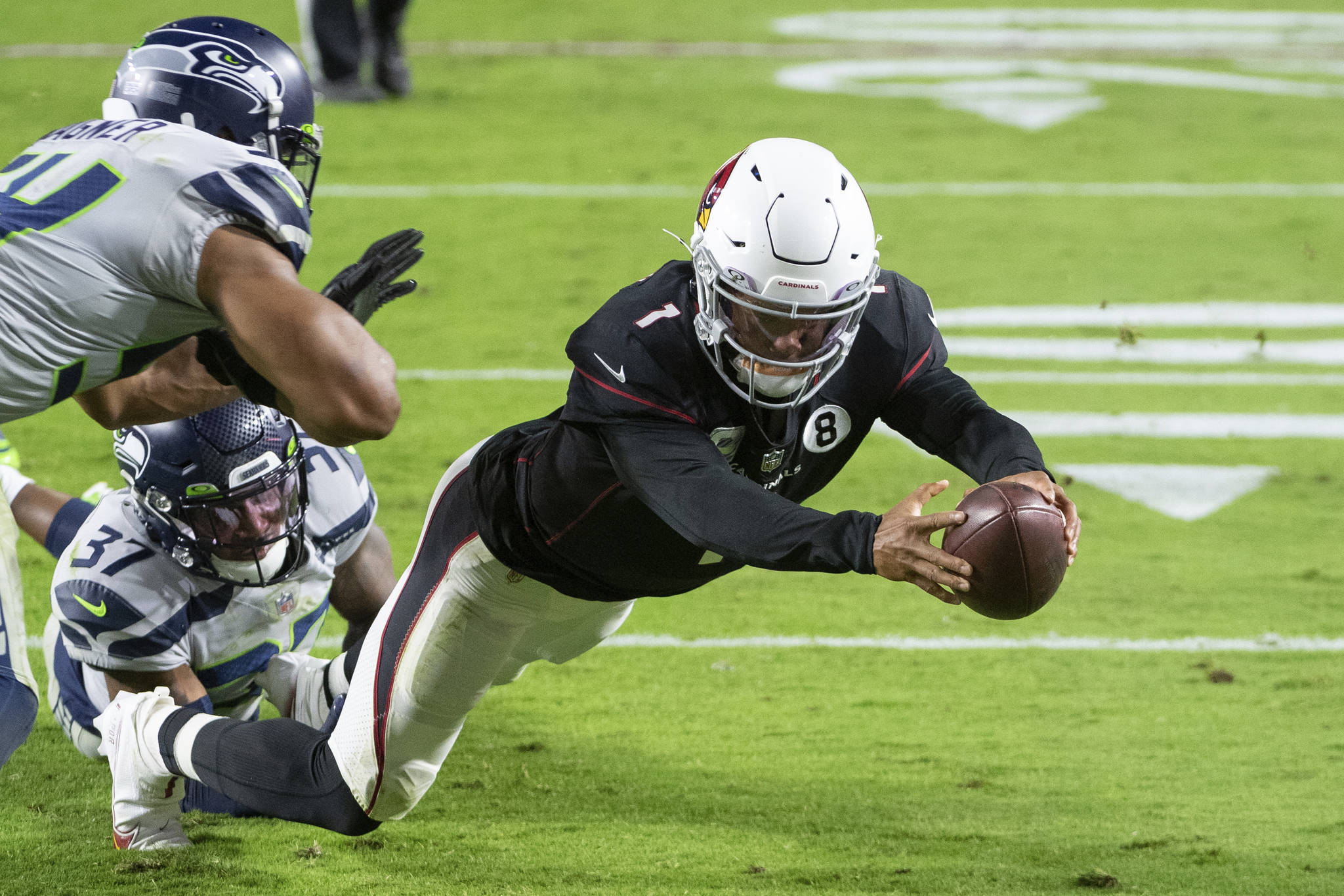 Arizona Cardinals quarterback Kyler Murray (1) dives in for a touchdown against Seattle Seahawks free safety Quandre Diggs (37) during last Sunday’s game in Glendale, Ariz. The Arizona Cardinals won in overtime. (AP Photo/Jennifer Stewart)