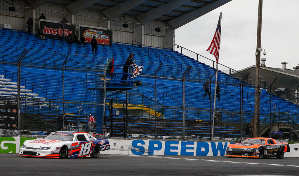 Tyson Lang (left) takes the checked flag with Daniel Moore coming second during the Central Welding Supply 125 for Pro Late Models at the Evergreen Speedway in Monroe on October 17, 2020. (Kevin Clark / The Herald)
