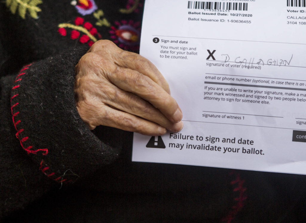 Doris Callaghan holds her signed ballot on Friday in Mukilteo. (Olivia Vanni / The Herald)
