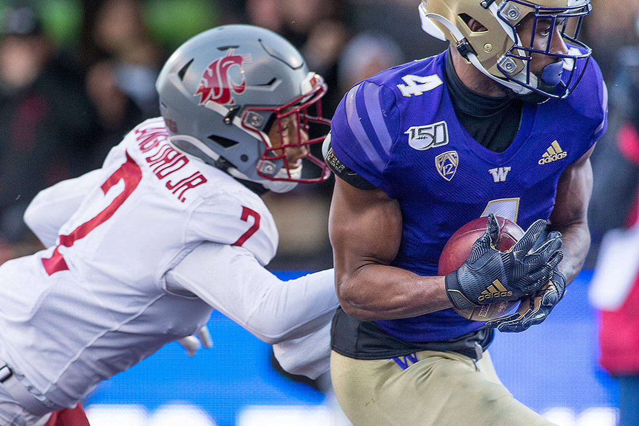 Both the Washington Huskies and Washington State Cougars have new head coaches and questions at quarterback entering the 2020 season. (Andy Bronson / The Herald)