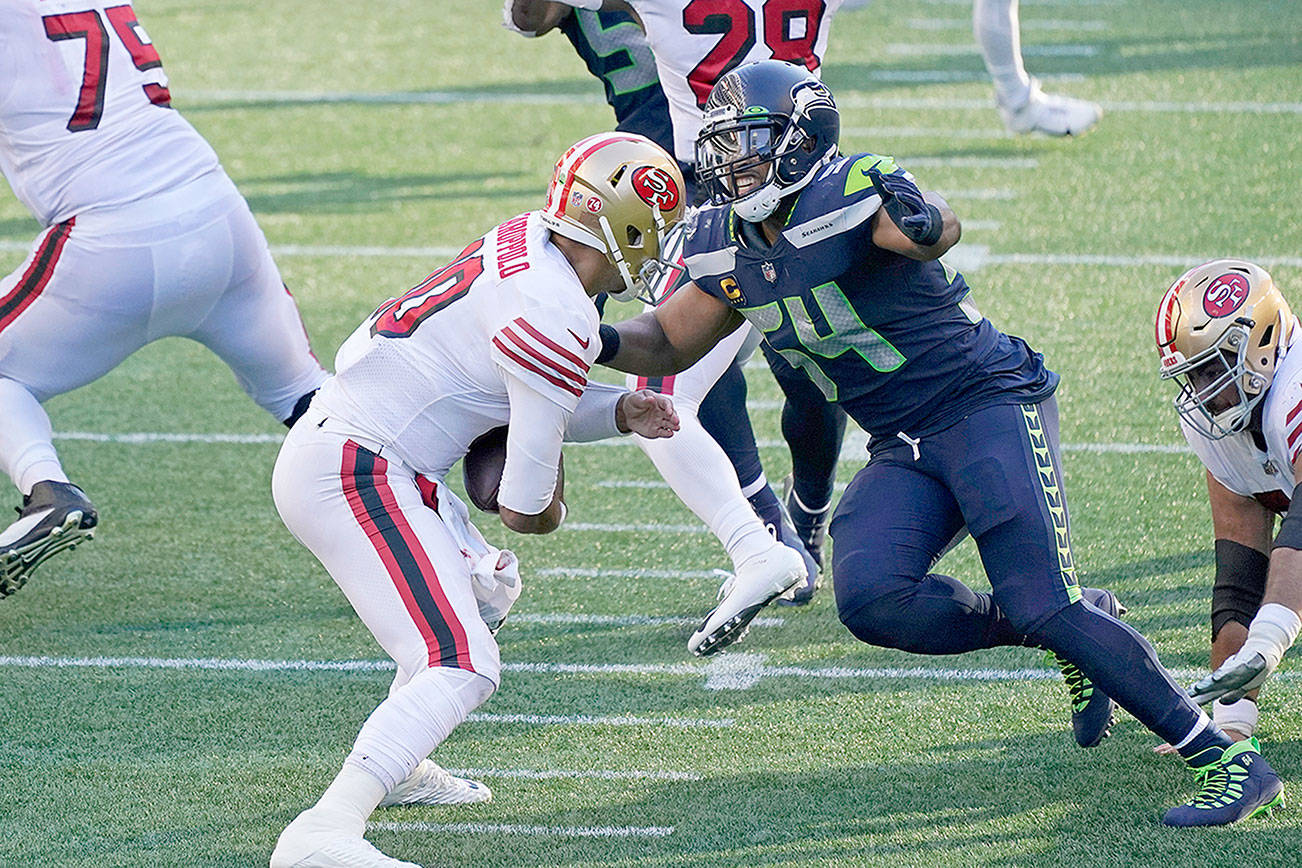 Seattle Seahawks middle linebacker Bobby Wagner, right, sacks San Francisco 49ers quarterback Jimmy Garoppolo during the first half of an NFL football game, Sunday, Nov. 1, 2020, in Seattle. (AP Photo/Elaine Thompson)