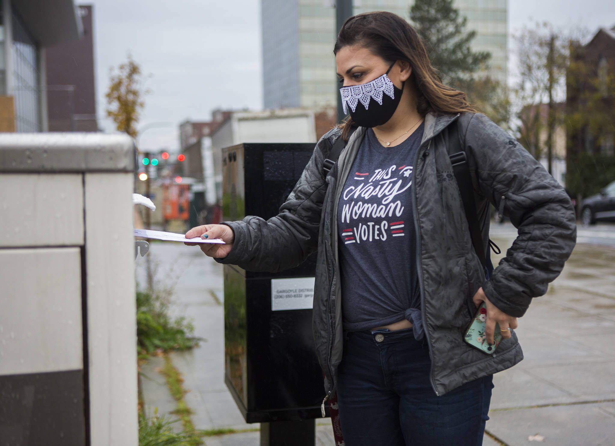 Taryn Hauglie wears a Ruth Bader Ginsburg-inspired mask while she turns in her ballot at the Snohomish County Campus ballot box on Tuesday in Everett. (Olivia Vanni / The Herald)