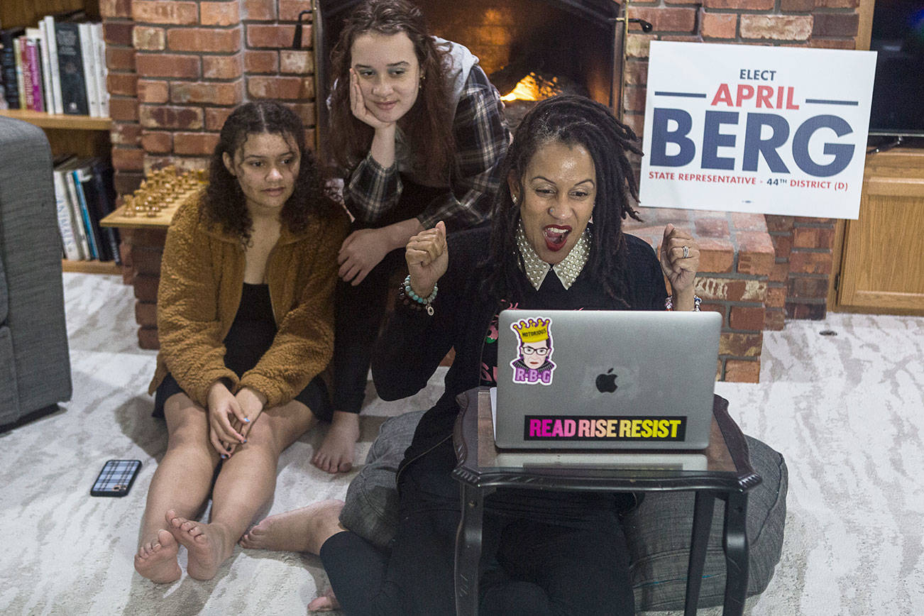Washington State Representative candidate April Berg, right, and daughters Simone Nowak, 16, center, and Camille Nowak, 14, right, react to election results putting her ahead of Mark James on Tuesday, Nov. 3, 2020 in Mill Creek, Wa. (Olivia Vanni / The Herald)