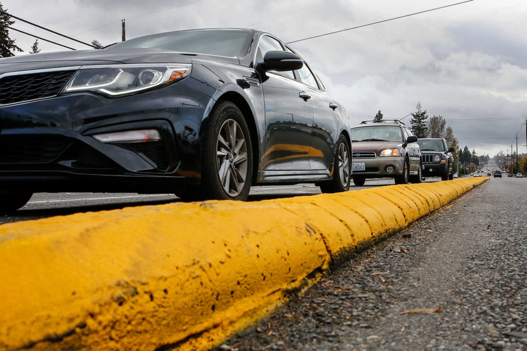 The median curb on northbound Highway 99 at 112th Street SW got a fresh coat of paint earlier this month. (Kevin Clark / The Herald)
