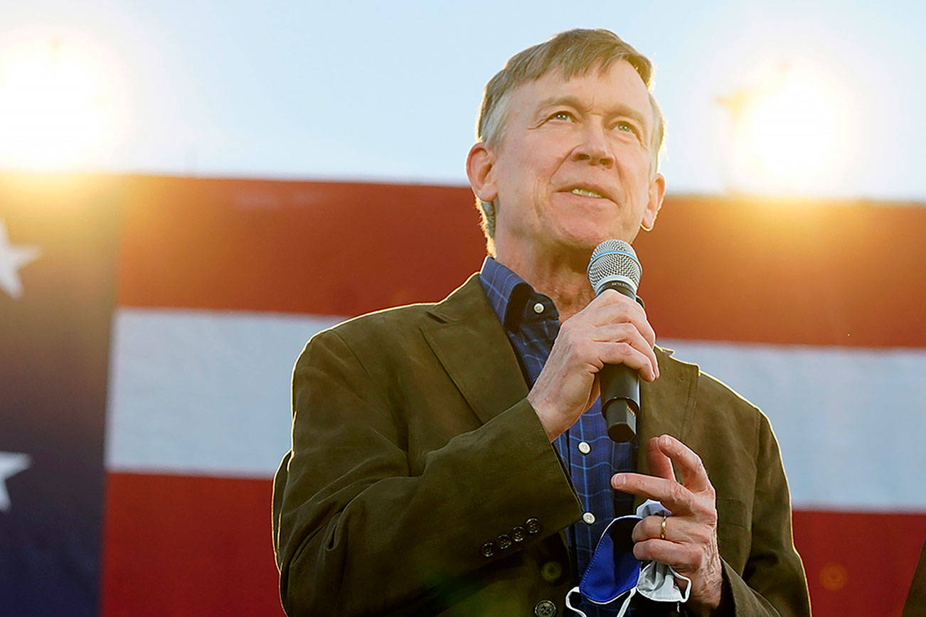 FILE—John Hickenlooper, Democratic candidate for the U.S. Senate seat in Colorado, speaks during a car rally for Doug Emhoff, husband of Democratic vice presidential candidate Kamala Harris, at East High School late Thursday, Oct. 8, 2020, in Denver. More than 70 motorists took part in the rally to urge people to get out and vote in the upcoming election. (AP Photo/David Zalubowski, File)