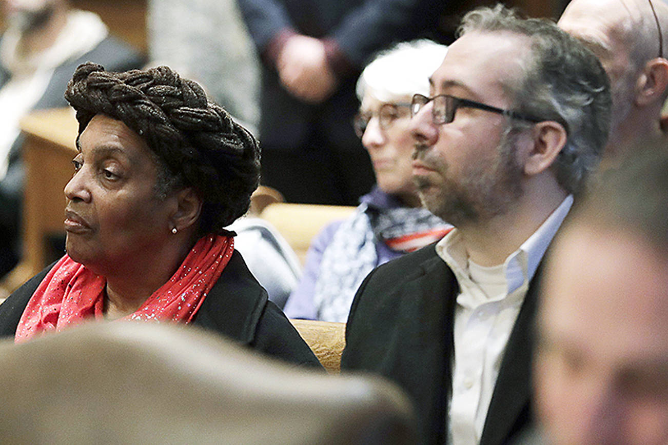 Washington state presidential electors Esther John, center, and Bret Chiafalo, right, sit behind their attorneys Tuesday, Jan. 22, 2019, during a Washington Supreme Court hearing in Olympia, Wash., on a lawsuit addressing the constitutional freedom of electors to vote for any candidate for president, not just the nominee of their party. (AP Photo/Ted S. Warren)
