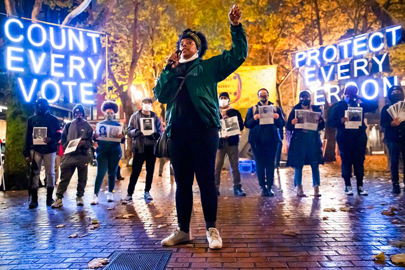 Travonna Thompson-Wiley, with Black Action Coalition, speaks at the Count Every Vote - Protect Every Person rally and march in Occidental Park in Seattle on Wednesday, Nov. 4, 2020. A coalition of groups organized the event, which drew hundreds of people. The coalition demanded that every vote is counted and orderly transition of power, as well as the elimination the electoral college, defunding the police, eradicating ICE/CBP and investing in Black communities. (Erika Schultz/The Seattle Times via AP)