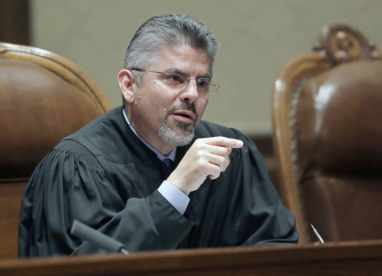 In this 2019 photo, Washington Supreme Court Justice Steven González listens to testimony during a hearing in Olympia. (AP Photo/Ted S. Warren, File)