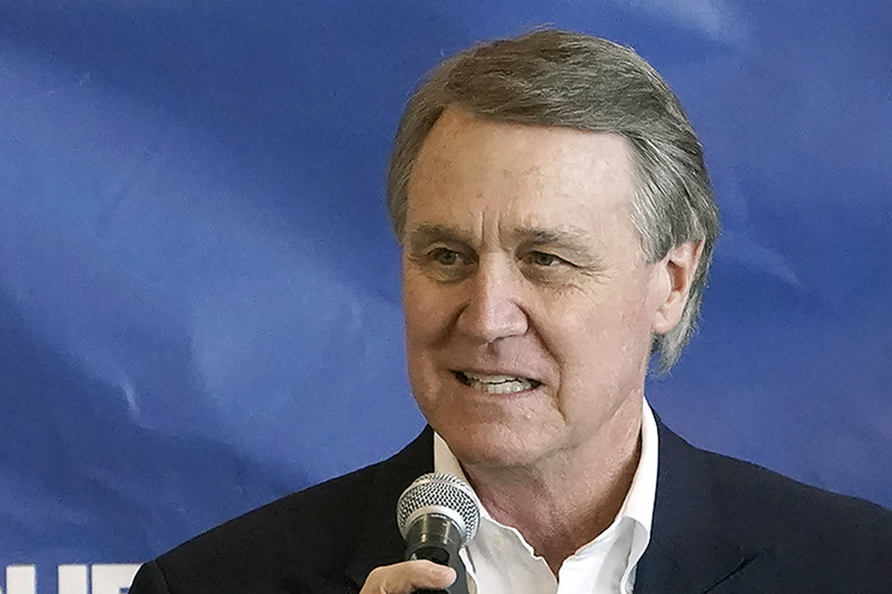 Republican candidate for Senate Sen. David Perdue speaks during a campaign stop at Peachtree Dekalb Airport Monday, Nov. 2, 2020, in Atlanta. The outcome in several contested states will determine whether Joe Biden defeats President Donald Trump. But if the Democratic challenger wins, the ambitions of a Biden presidency could well come down to Georgia. (AP Photo/John Bazemore)