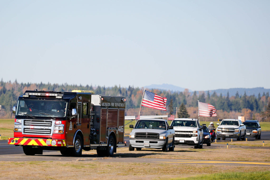 A parade led by the Arlington Fire Department makes its way down the runway to celebrate Art Unruh’s 98th birthday Sunday afternoon at the Arlington Airport. (Kevin Clark / The Herald)
