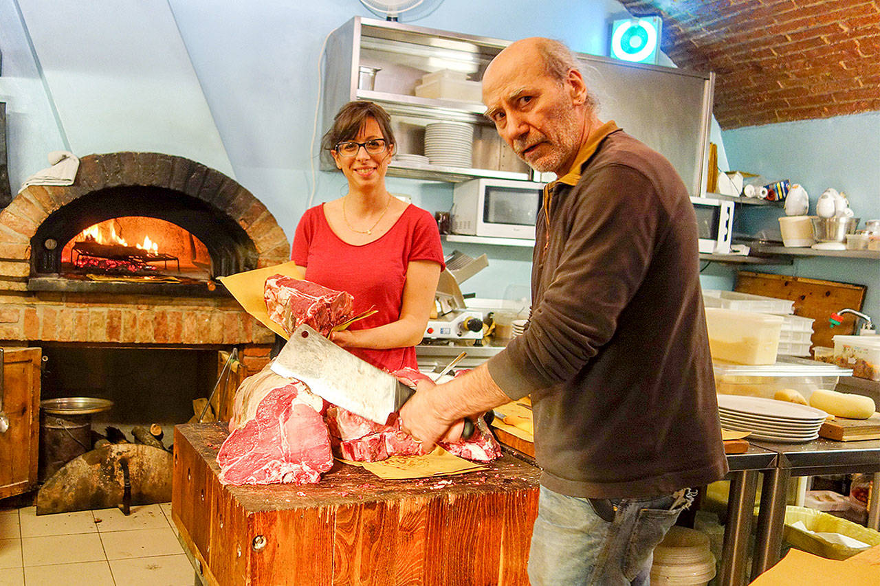 At Rick Steves’ favorite steakhouse in Montepulciano, Italy, the chef cuts steaks off a hunk of beef, then grills them for seven minutes a side. (Rick Steves’ Europe)