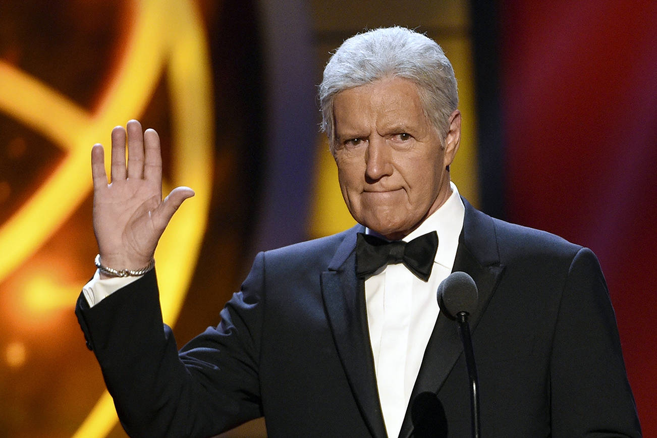 FILE - This May 5, 2019, file photo shows Alex Trebek gestures while presenting an award at the 46th annual Daytime Emmy Awards in Pasadena, Calif. Jeopardy!” host Alex Trebek died Sunday, Nov. 8, 2020, after battling pancreatic cancer for nearly two years. Trebek died at home with family and friends surrounding him, “Jeopardy!” studio Sony said in a statement. Trebek presided over the beloved quiz show for more than 30 years. (Photo by Chris Pizzello/Invision/AP, File)