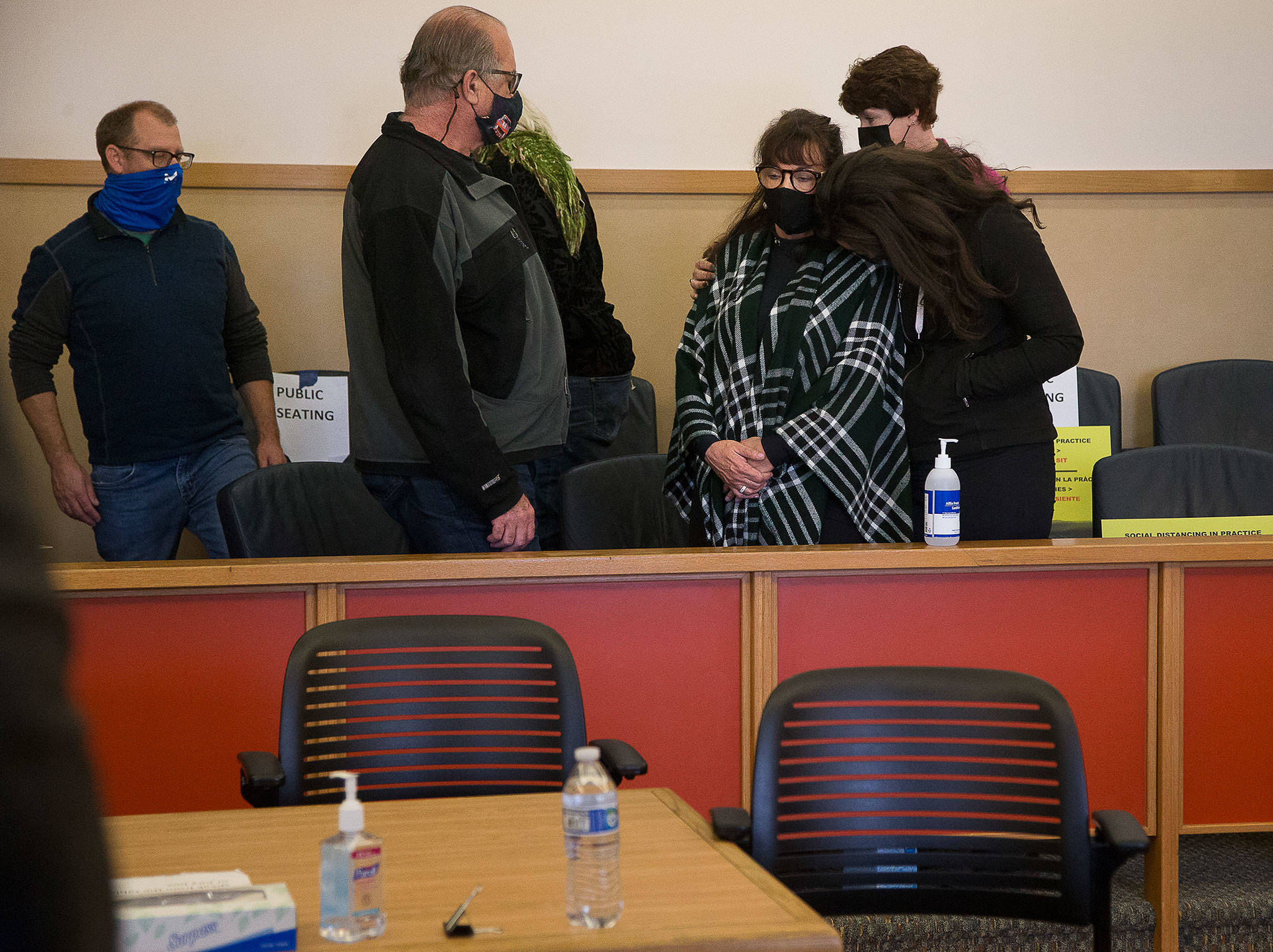 Terrence Miller, 78, was found guilty Monday in the 1972 murder of Jody Loomis, 20. Miller took his own life as jurors deliberated. Here the victim’s sister, Jana Loomis-Smith (in plaid shawl), is comforted by her daughter at the Snohomish County Courthouse in Everett. (Andy Bronson / The Herald)