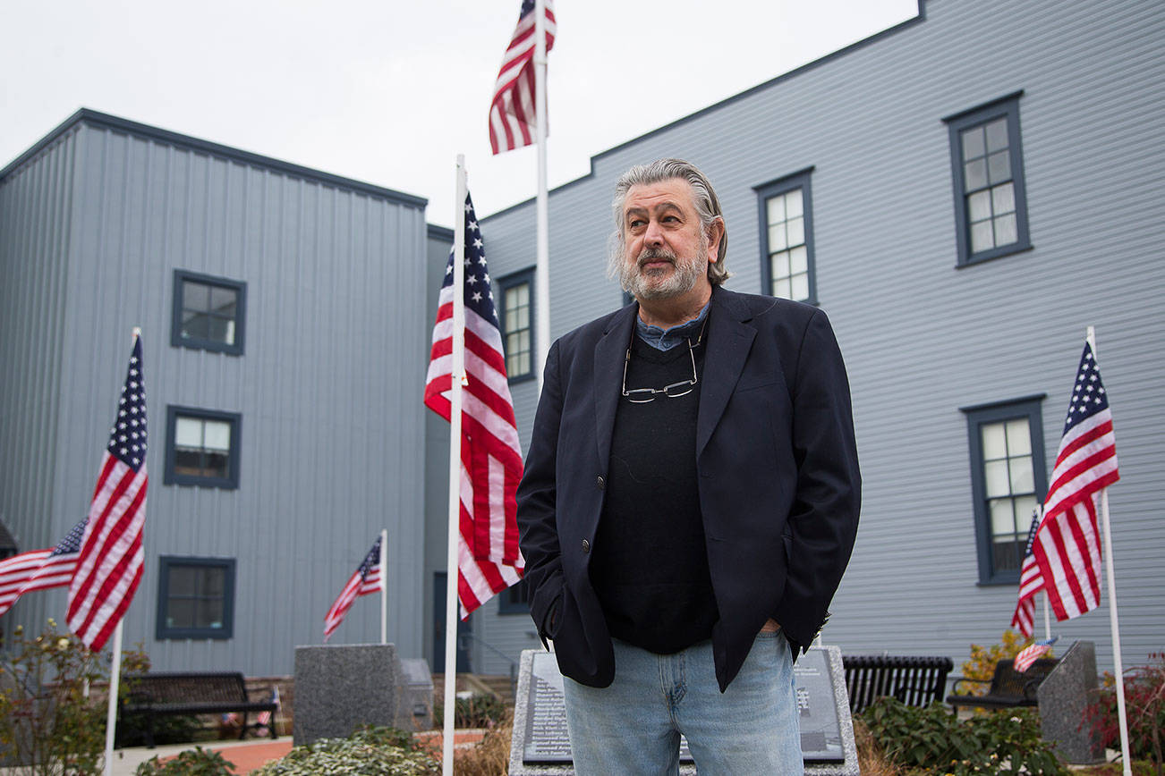 Richard Hanks talks about his book "Solemn, the Drums Thrill: Essays on the Fallen Heroes of Stanwood Camano: WW I to Afghanistan" outside the Stanwood Area Historical Society on Wednesday, Nov. 11, 2020 in Stanwood, Washington. (Andy Bronson / The Herald)