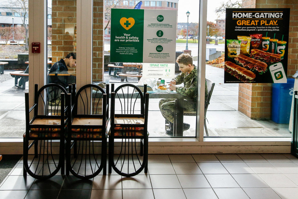 Diners eat outside The Commons on Friday at Naval Station Everett. (Kevin Clark / The Herald)
