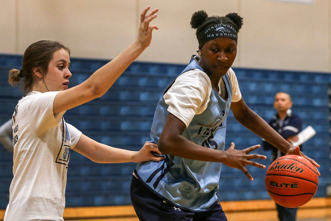 Fatoumata Jaiteh (right) works the post with Maia Austvold defending during practice Thursday afternoon at Meadowdale High School in Lynnwood on February 20, 2019.  (Kevin Clark / The Herald)