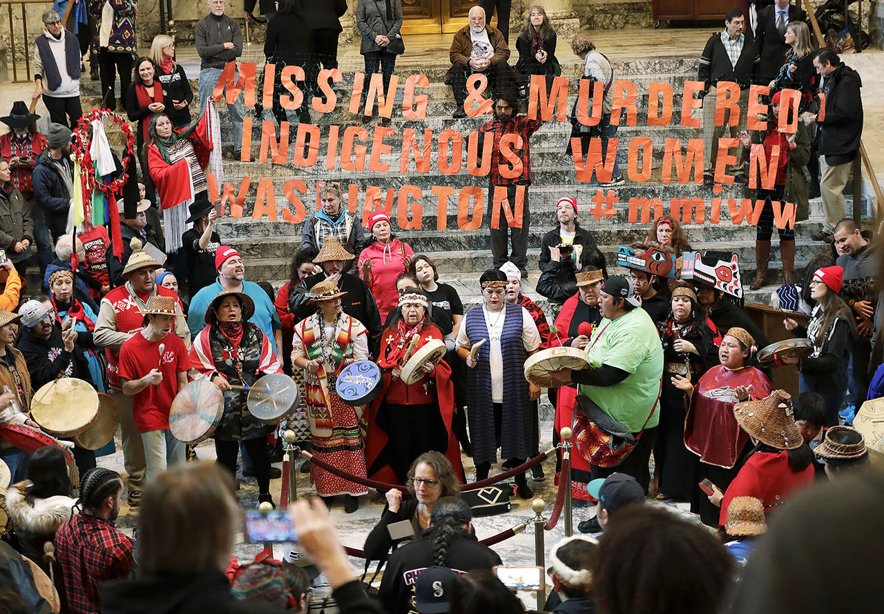 Native American tribal members sing and drum in the rotunda of the Capitol in Olympia in 2018. (AP Photo/Ted S. Warren, file)