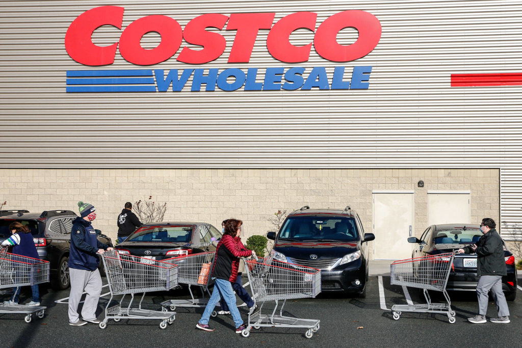 The line to get into Costco grows Sunday morning in Lynnwood. (Kevin Clark / The Herald)
