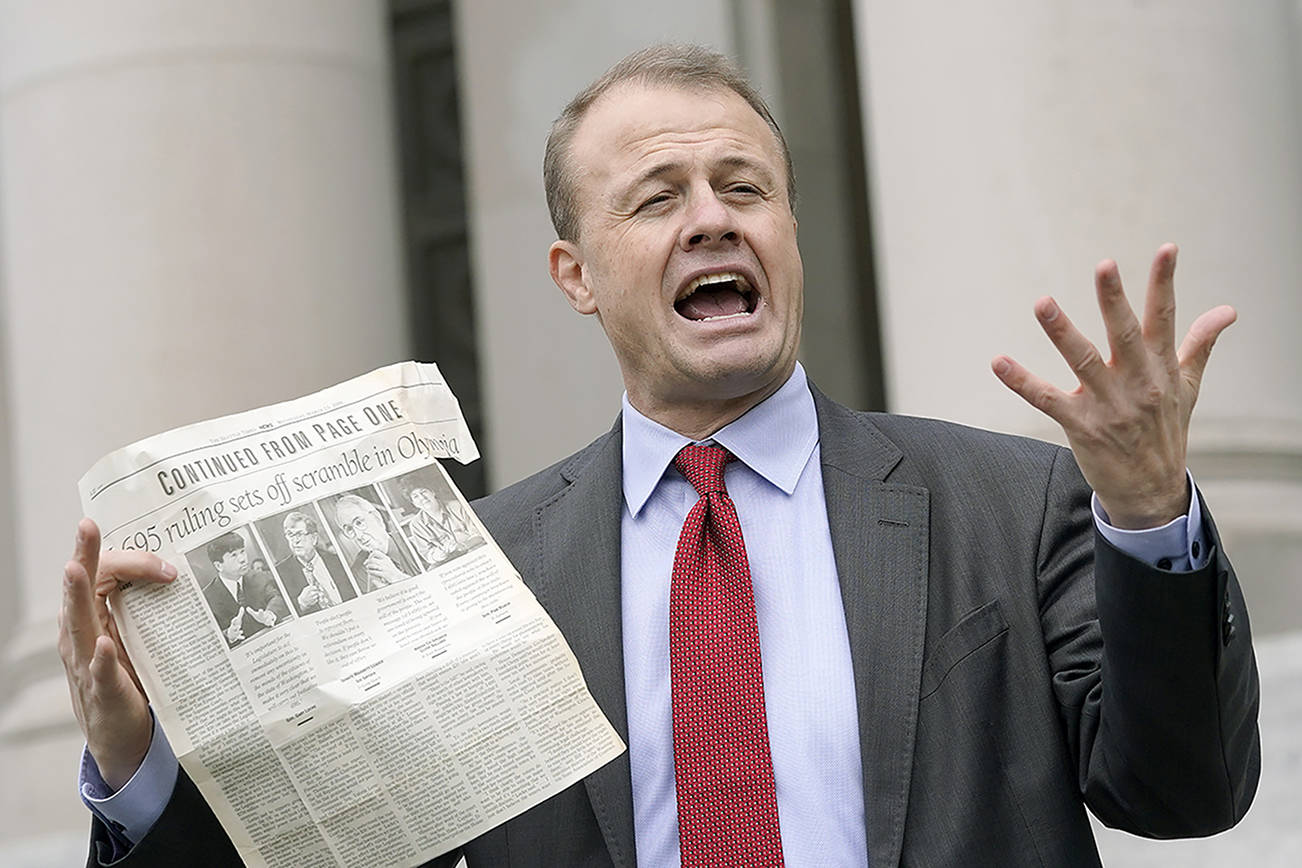 Initiative promoter Tim Eyman talks to reporters, Thursday, Oct. 15, 2020, in front of the Temple of Justice at the Capitol in Olympia, Wash. The Washington Supreme Court on Thursday unanimously struck down Eyman's Initiative 976, a measure that would have steeply discounted the price of car registrations at $30 while gutting transportation budgets across Washington state. (AP Photo/Ted S. Warren)