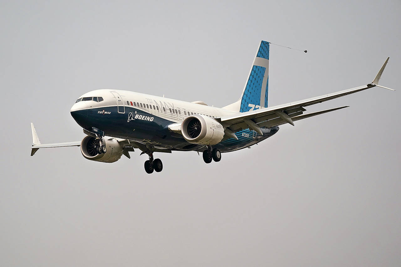 In this Sept. 30 photo, a Boeing 737 Max jet, piloted by Federal Aviation Administration Chief Steve Dickson, prepares to land at Boeing Field following a test flight in Seattle. (AP Photo/Elaine Thompson, File)