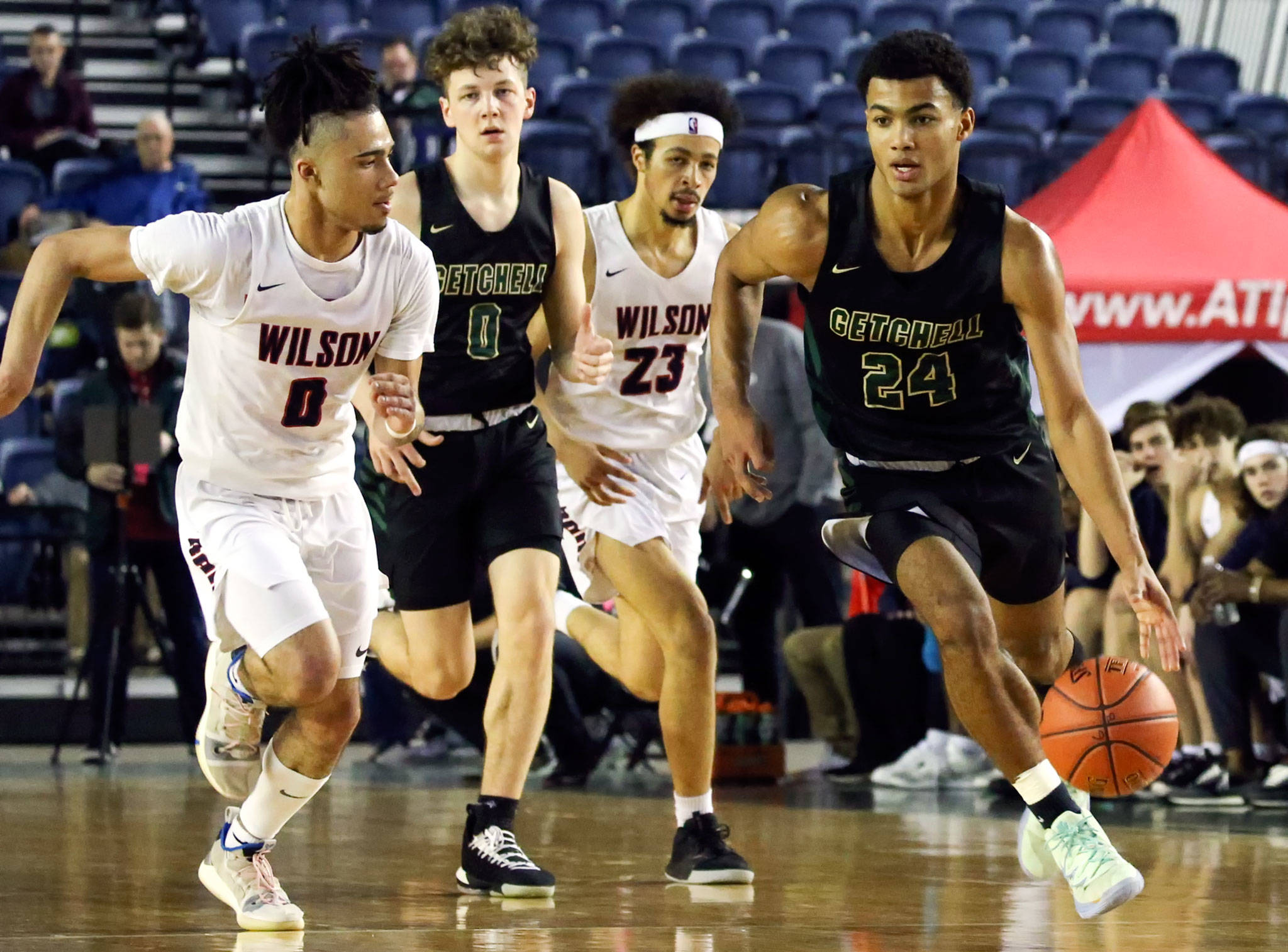 Marysville Getchell’s Malakhi Knight races down the court past Wilson defenders at the Tacoma Dome on March 4. (Kevin Clark / The Herald)