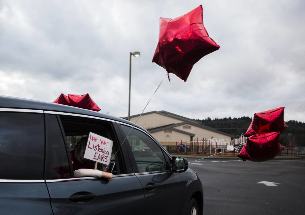 A sign on a car during a parade and rally in support of teachers on Thursday in Monroe. (Olivia Vanni / The Herald)
